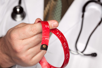 Doctor with Stethoscope Holding Measuring Tape