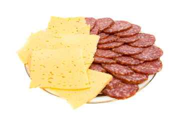 The cut salami and cheese on a plate. Isolated on white