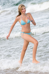 Young girl running at the beach