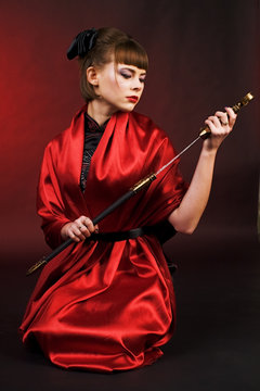 girl in red kimono with katana