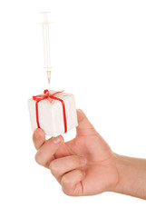 Hand holds gift with the thrust syringe