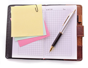 Open notebook with a pen on white