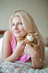Young beautiful girl relaxing with a toy