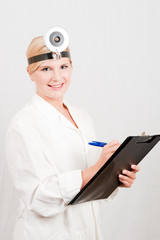 Female doctor writing notes in the folder