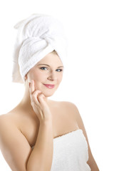 Young healthy woman in towel touching skin