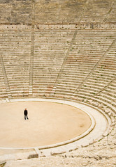 Tourist in ancient theater in Epidaurus, Greece