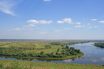 Fototapeta na wymiar The sinuous river on green plain