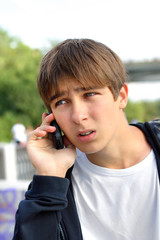 The irritation teenager receives bad news by phone