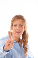 Young smiling woman making victory gesture