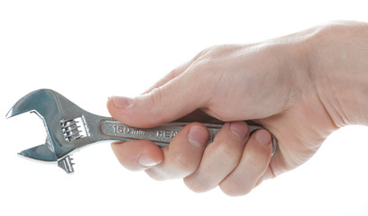 Male hand holding the adjustable spanner isolated