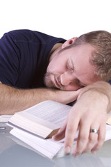 College Student Sleeping on his Desk