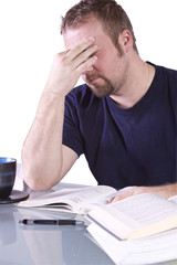 Frustrated College Student with Books on the Table Studying