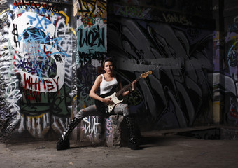 Fototapeta na wymiar young and sexy female rock musician with her guitar
