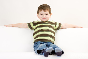 Cute preschool boy on sofa