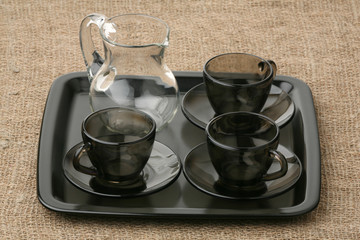 Three coffee pairs and jug on a tray