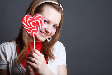 Portrait of beautiful girl with big lollipop