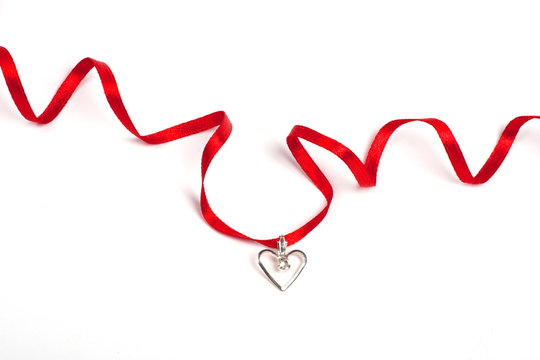 Red ribbon with heart, Isolated over white