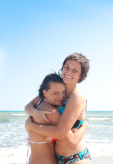 two girls having fun on the beach