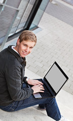 Young happy man with laptop