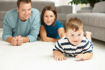 Family lying on carpet