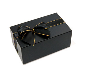 Black giftbox with a black and gold knot white isolated