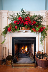 Beatifully decorated fireplace with lit fire