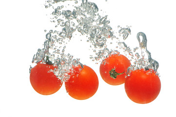 Tomatoes falling in water