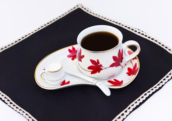 Cup of coffee and small cup with milk