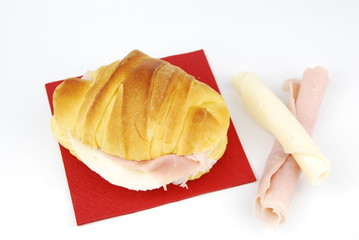 Cheese and ham croissant on a red napkin