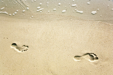 human adult footprint in the fine sand at the beach