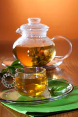 Glass of greean tea and teapot
