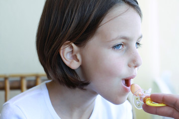older child with pacifier