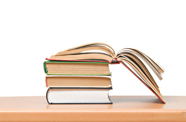 Open book on desk isolated on white background