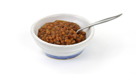 Baked beans in old bowl with spoon