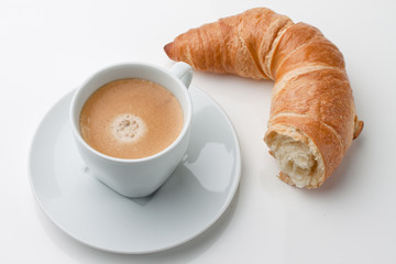 Croissants, pastries and coffee in the cup for breakfast