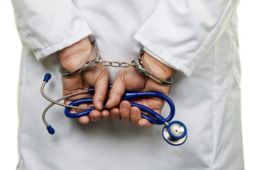 Doctor with stethoscope and handcuffs