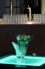 Hotel ballroom with luminous bar tables and a bar unit