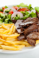 Grilled meat with fried potatoes and vegetables
