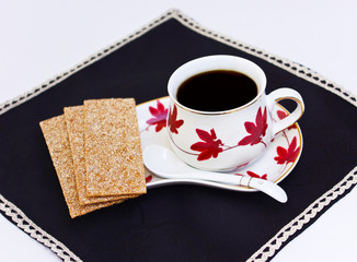 Bread and cup of coffee on napkin