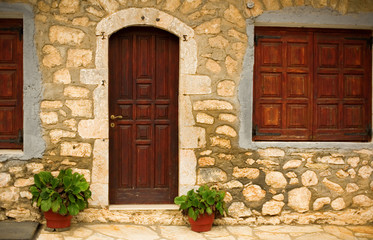 Fototapeta na wymiar Stone wall of a rural house in a famous Greek village Stemnitsa