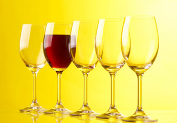 Wine glasses on yeloow background..