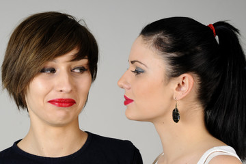 two happy young women smiling