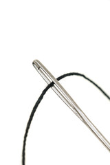 Macro of needle eye and threaded sewing