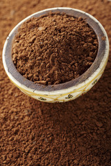 cocoa powder with small pieces of chocolate in bowl, on its back