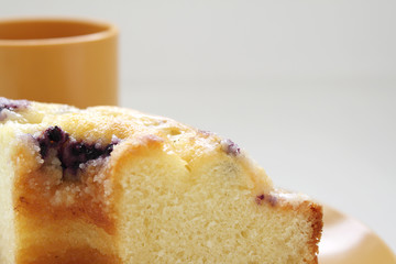 Sliced blueberry cake and a cup of green tea