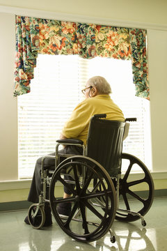 Elderly Man in Wheelchair by Window