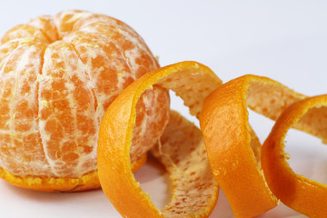 A peeled orange on a white background