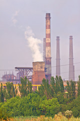 Factory with smokestacks doing air pollution