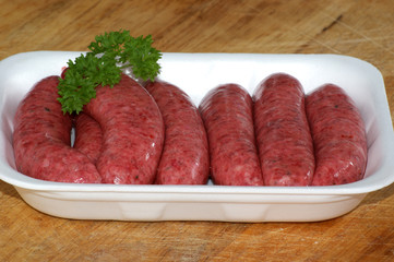 some organic raw beef sausages  and parsley
