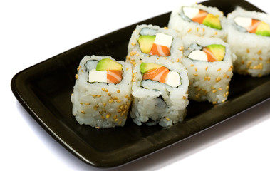 Six california rolls on a plate isolated on white